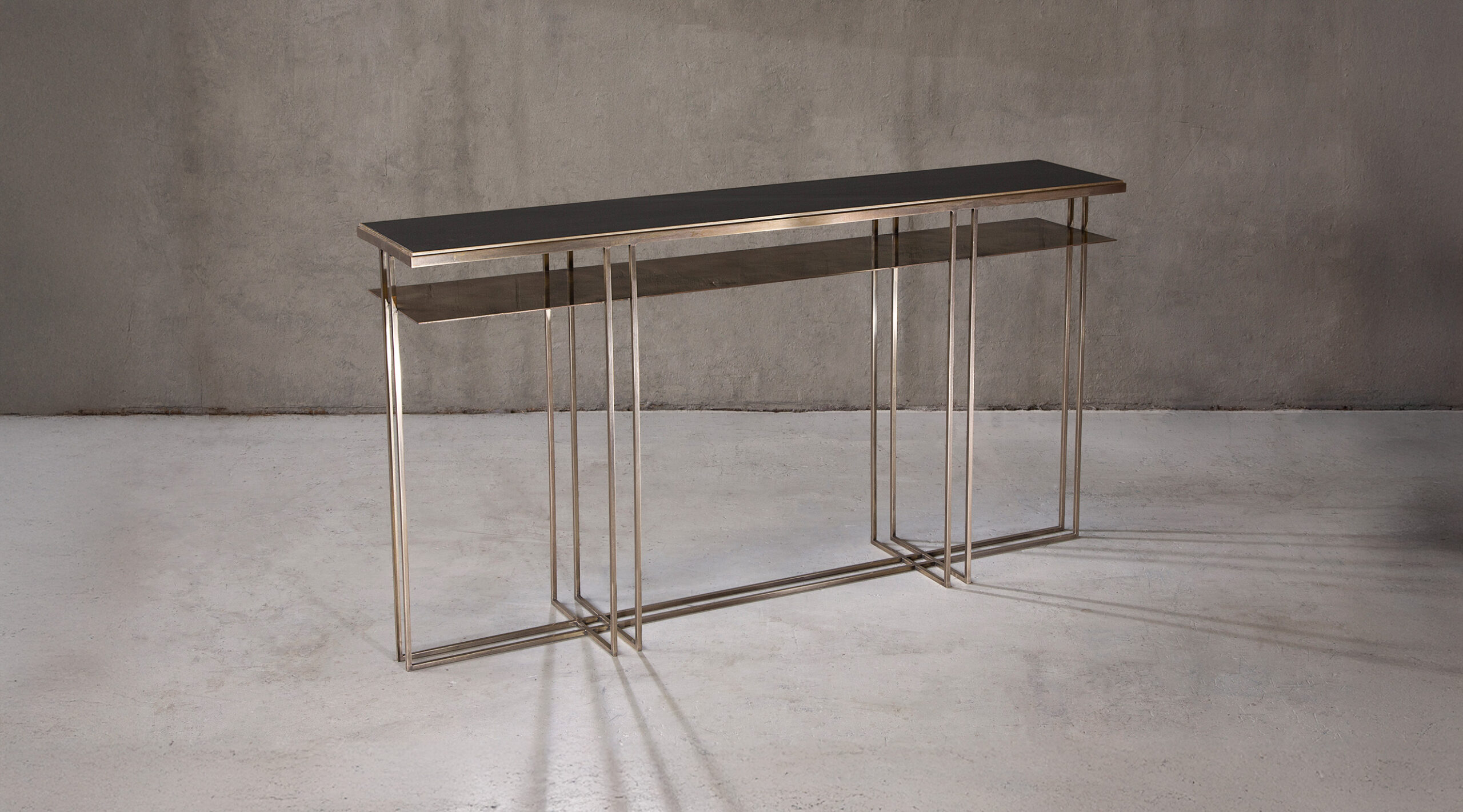 A console table in polished brass and honed Cumbrian slate.