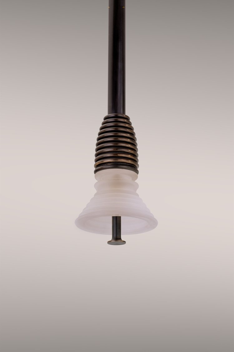 Pendant light in dark brass.