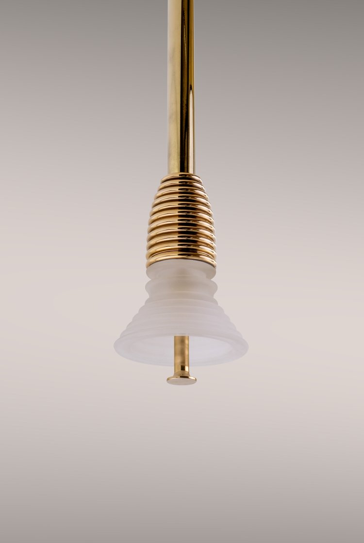 Pendant light in polished brass.