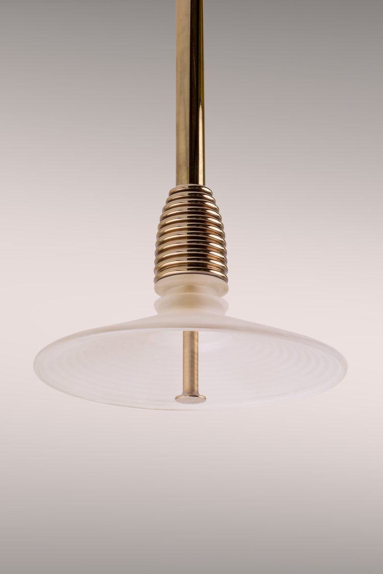 Pendant light in polished brass, frosted glass
