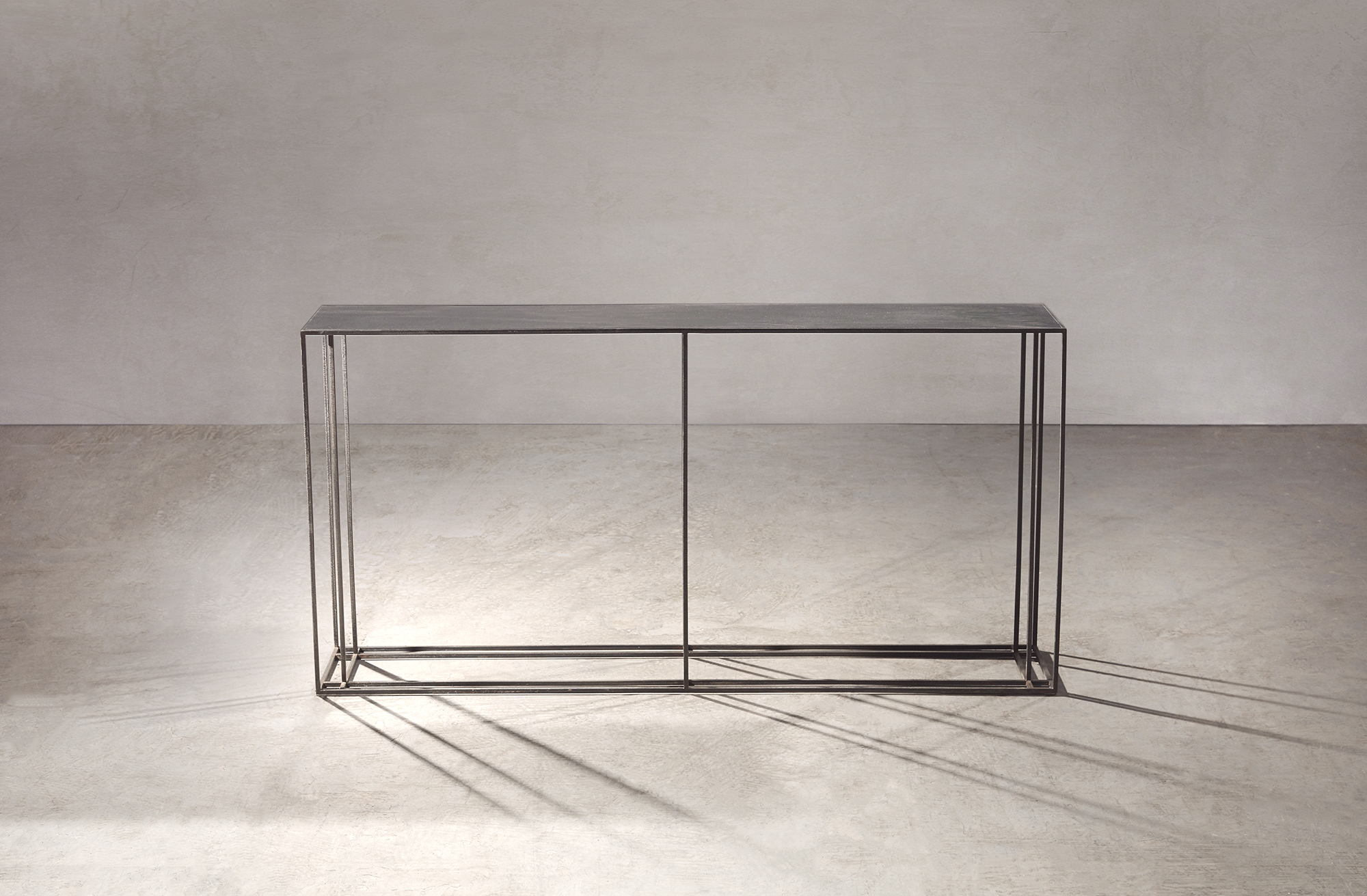 A console table in black patinated steel.