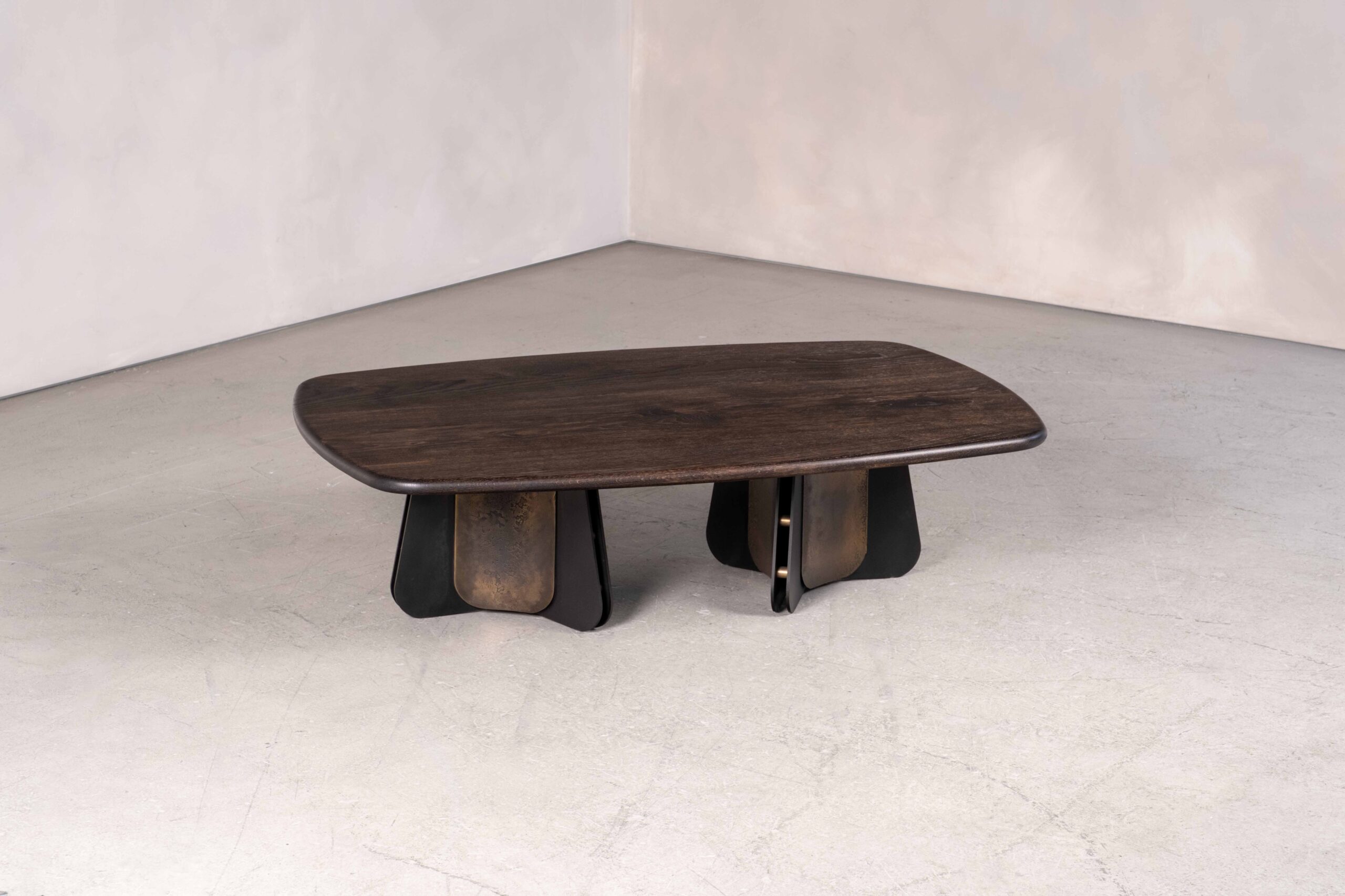 The Propeller coffee table in metal and wood, shown is the double pedestal base option in blackened steel, light-etched brass and bullnosed dark oak. bullnosed ebonised oak.