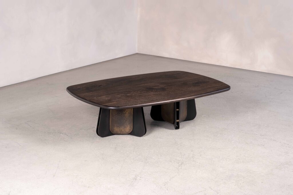 The Propeller coffee table in metal and wood, shown is the double pedestal base option in blackened steel, light-etched brass and bullnosed dark oak. bullnosed ebonised oak.