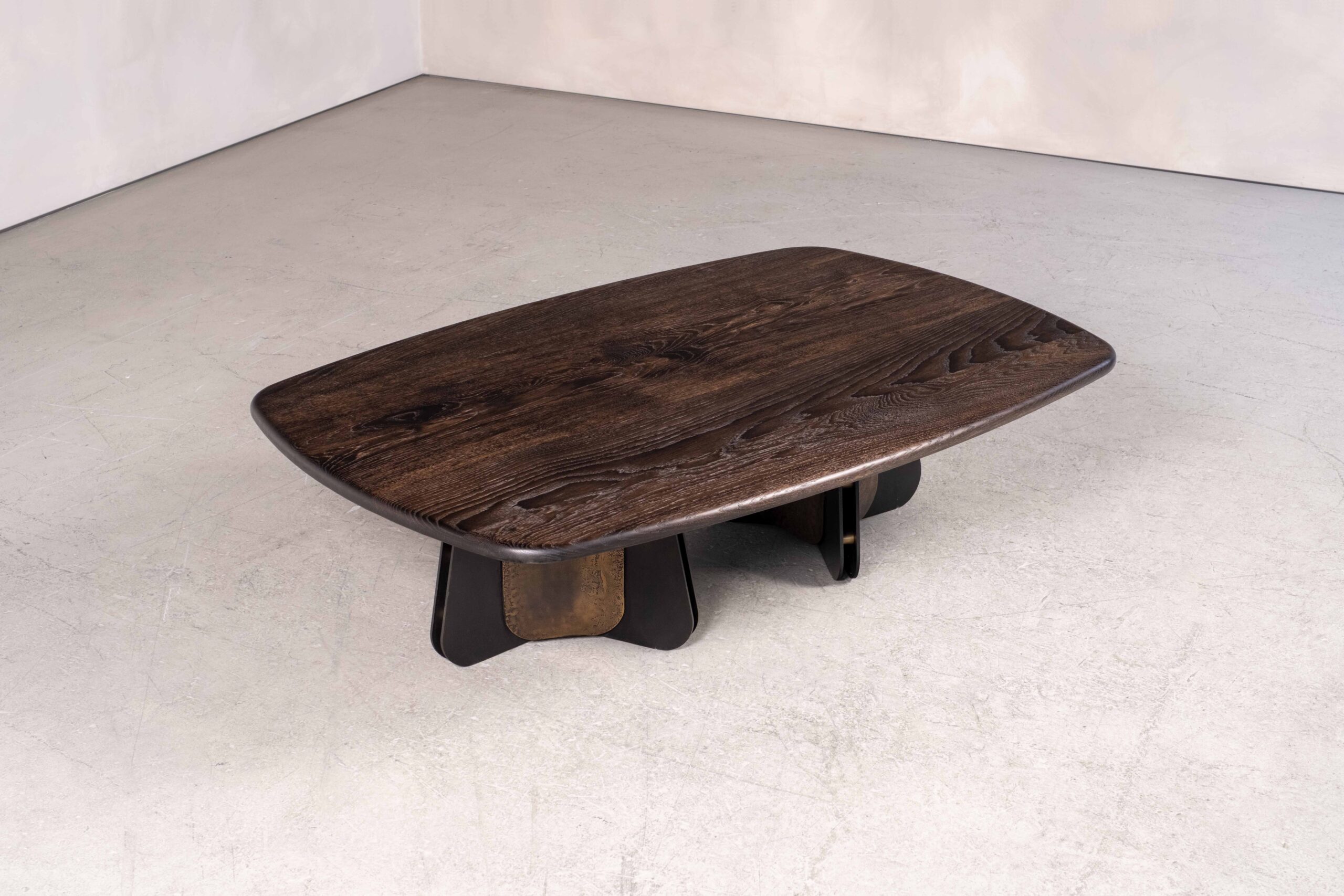 The Propeller coffee table in metal and wood, shown is the double pedestal base option in blackened steel, light-etched brass and bullnosed ebonised oak.